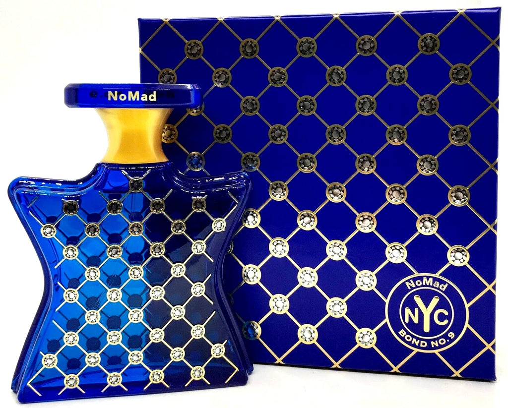 Blue and gold perfume bottle with matching box featuring 'NoMad NYC' branding.