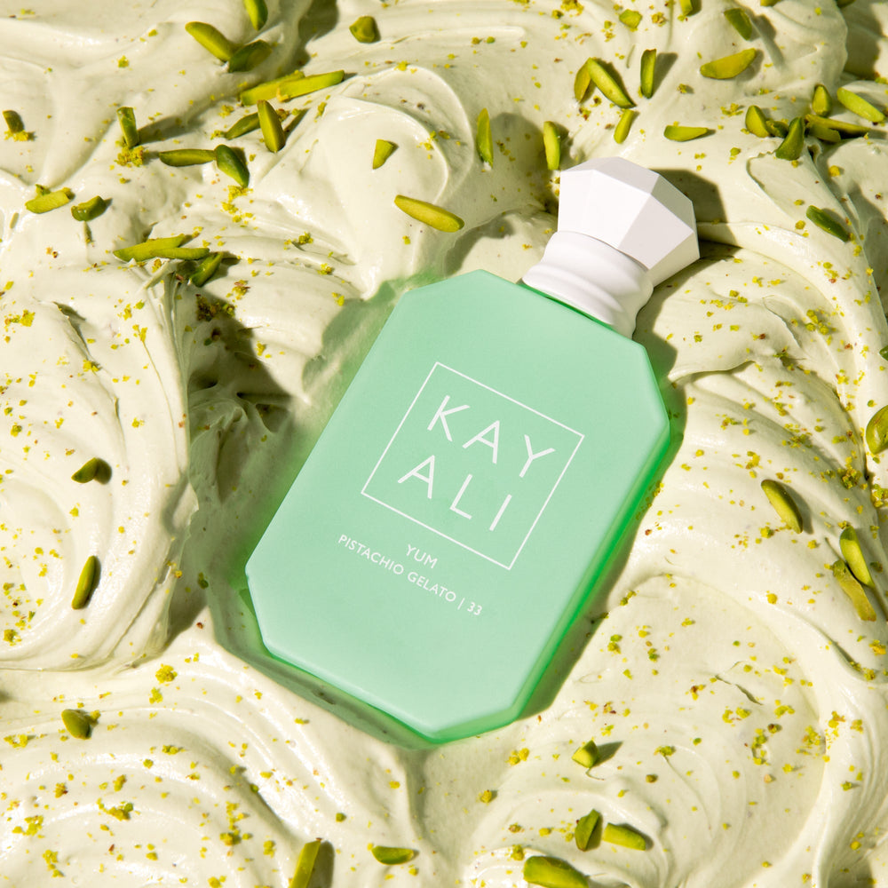 Green bottle with 'KAY ALI' branding on a dessert background