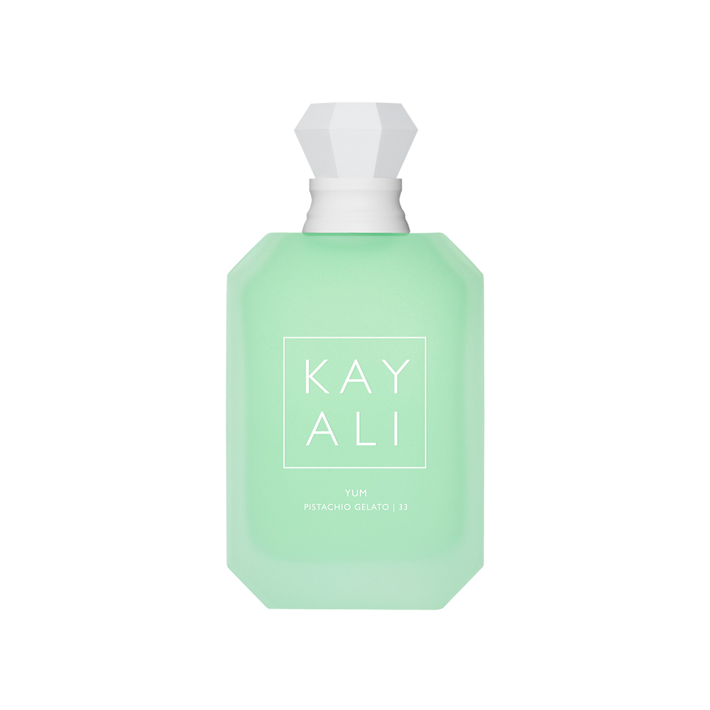 Green perfume bottle with white cap on a white background
