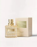 Perfume bottle and packaging with 'Ferragamo' branding on a light gray background