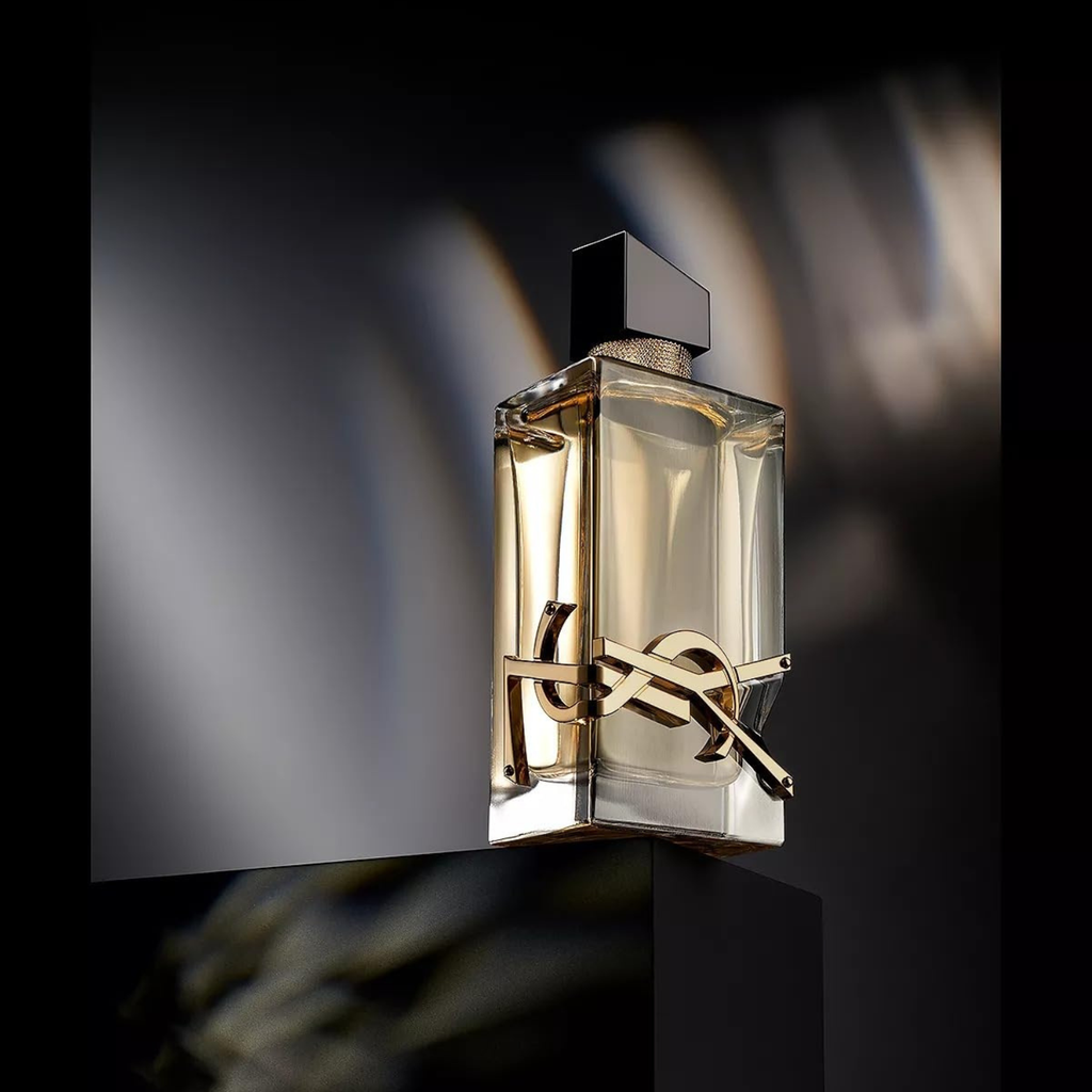 Perfume bottle with a brand logo on a dark background