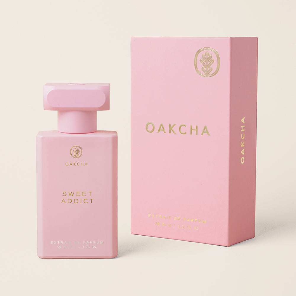 Pink Oakcha perfume bottle and packaging on a light beige background