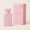 Pink Oakcha perfume bottle and packaging on a light beige background