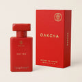 Red Oakcha perfume bottle and packaging on a beige background